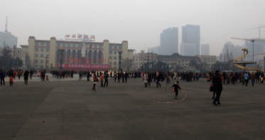People gather on Tianfu Square despite the pollution.